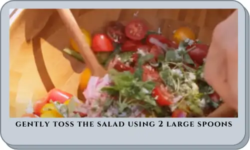 gently toss the salad using 2 large spoons