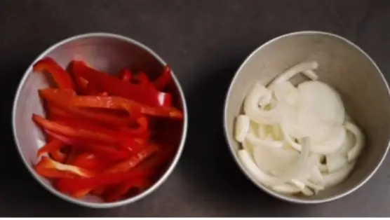 Finely slice the onion and red peppers