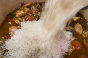 adding rice to the pot for Jambalaya Recipe