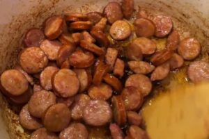 cooking sliced smoked sausage for Jambalaya